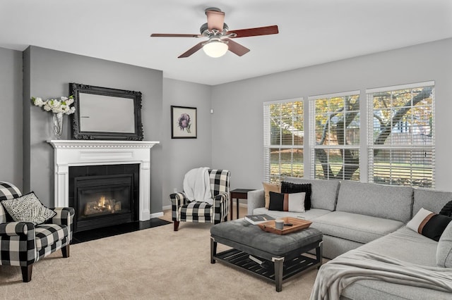 living room featuring ceiling fan and a fireplace