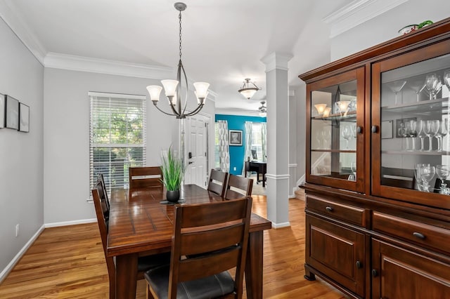 dining room featuring light hardwood / wood-style flooring, ornamental molding, and a healthy amount of sunlight