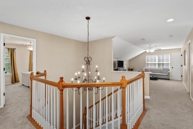 hall with light carpet and vaulted ceiling