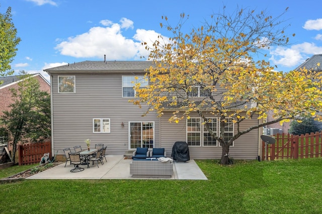 rear view of house with an outdoor living space, a patio, and a lawn