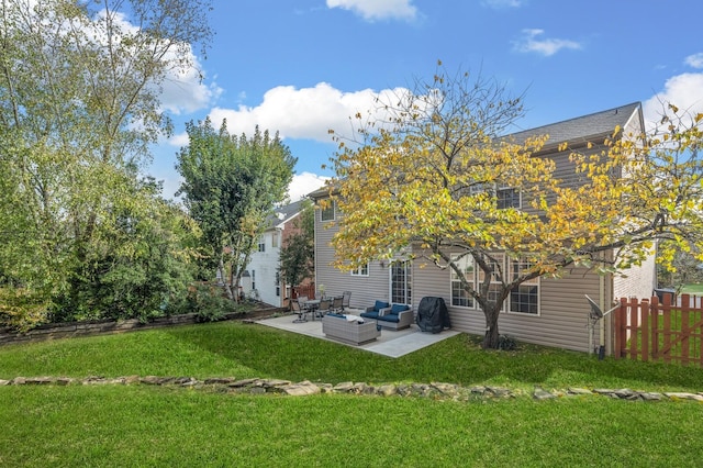 rear view of property featuring an outdoor hangout area, a patio area, and a lawn