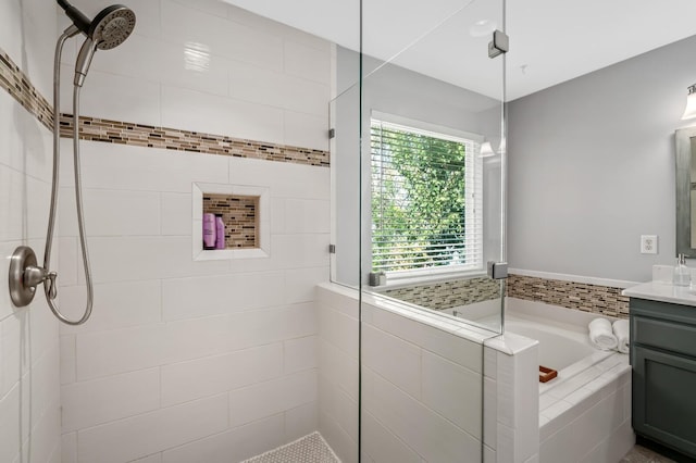 bathroom featuring vanity and shower with separate bathtub