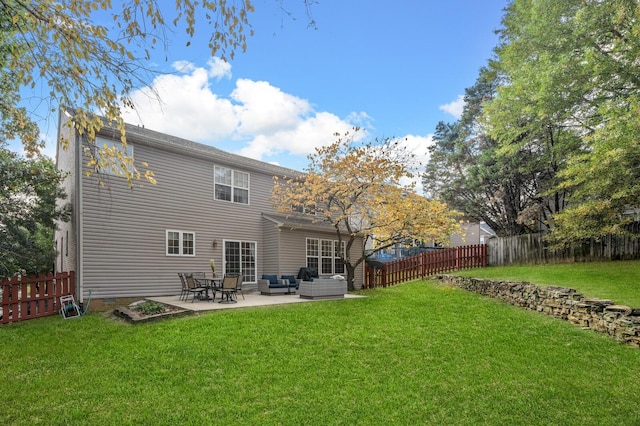 back of property with an outdoor hangout area, a patio, and a lawn