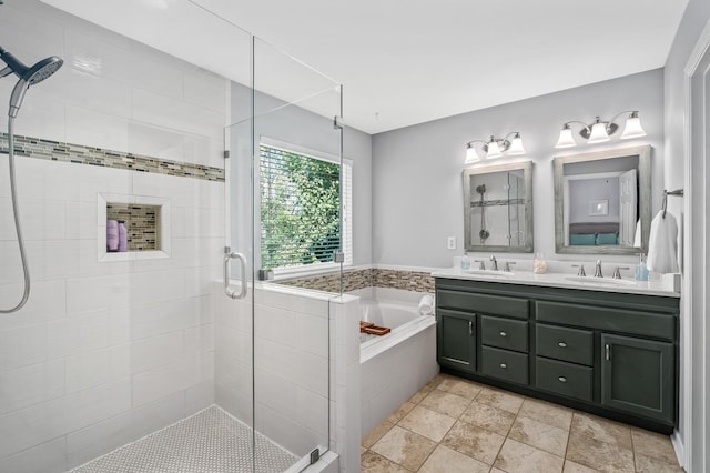 bathroom with vanity and shower with separate bathtub