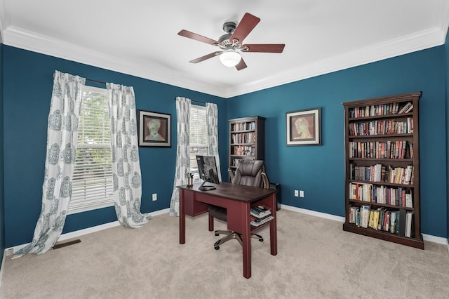 home office with ornamental molding, a healthy amount of sunlight, and light colored carpet