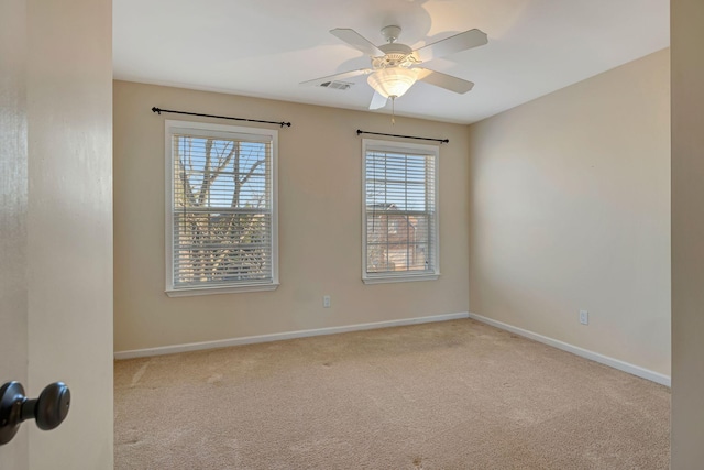 carpeted empty room with plenty of natural light and ceiling fan