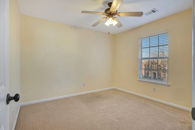 empty room featuring light colored carpet and ceiling fan