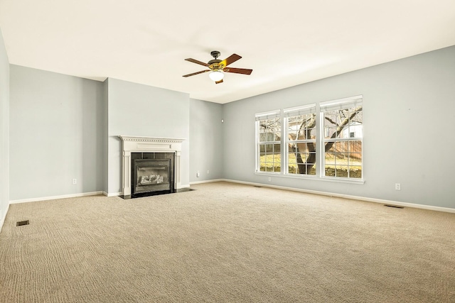 unfurnished living room with a fireplace with flush hearth, carpet floors, and baseboards