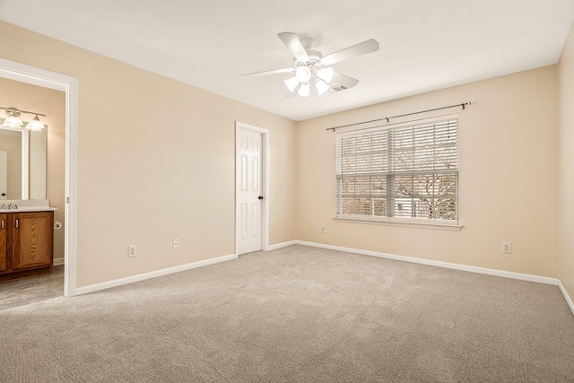 unfurnished bedroom featuring visible vents, baseboards, a ceiling fan, connected bathroom, and light colored carpet