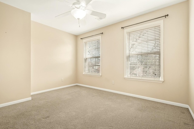 unfurnished room featuring carpet floors, a ceiling fan, and baseboards