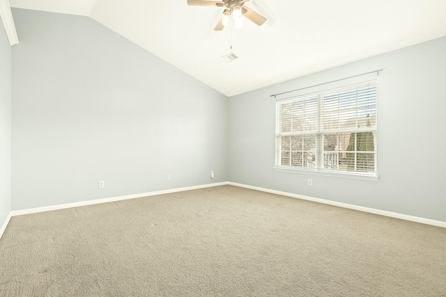 spare room with carpet flooring, vaulted ceiling, baseboards, and ceiling fan