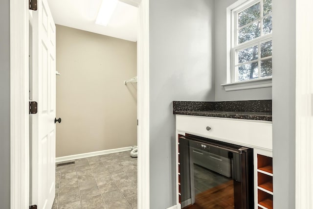 interior space featuring beverage cooler and baseboards