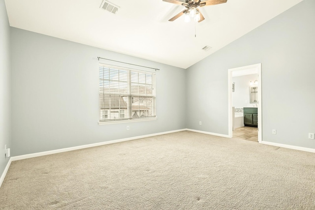 empty room with ceiling fan, lofted ceiling, light carpet, visible vents, and baseboards