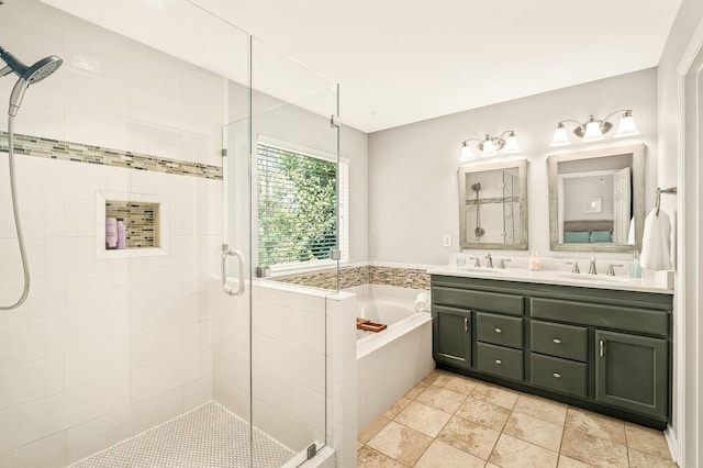 bathroom featuring double vanity, a garden tub, a shower stall, and a sink