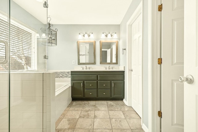 bathroom featuring a bath, double vanity, and a sink