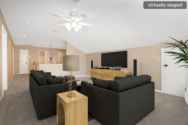 living area featuring a ceiling fan, lofted ceiling, carpet flooring, and baseboards