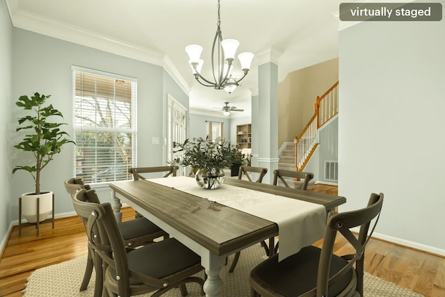 dining area with a chandelier, crown molding, stairway, and light wood finished floors