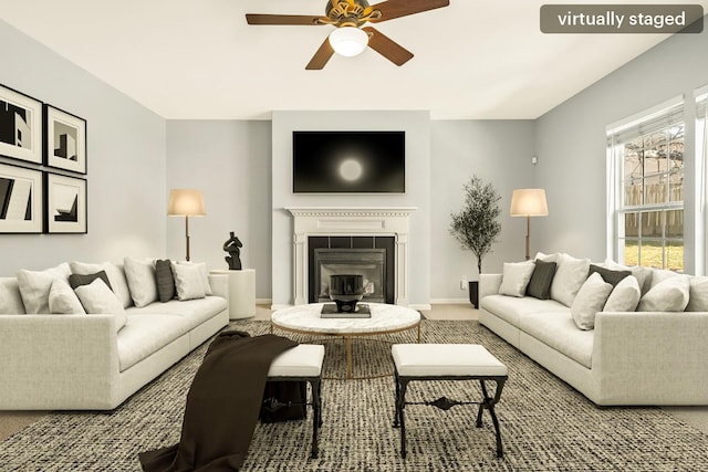 living room featuring carpet, a glass covered fireplace, a ceiling fan, and baseboards