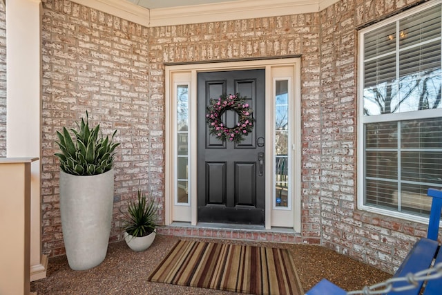 doorway to property with brick siding