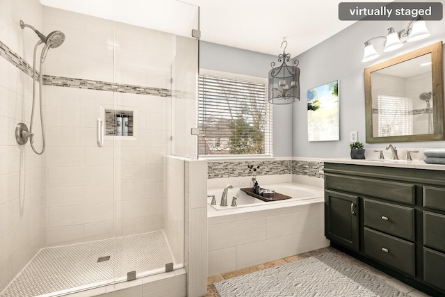 full bathroom featuring a stall shower, vanity, a bath, and tile patterned floors