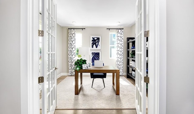 office space with hardwood / wood-style floors and french doors