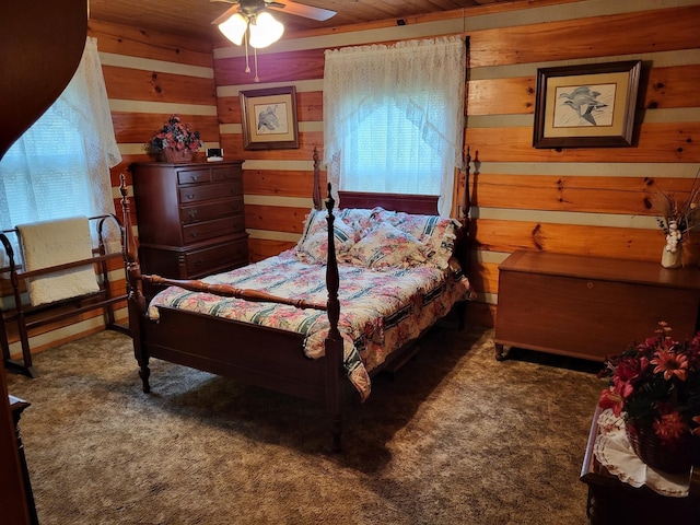 bedroom with ceiling fan and dark colored carpet