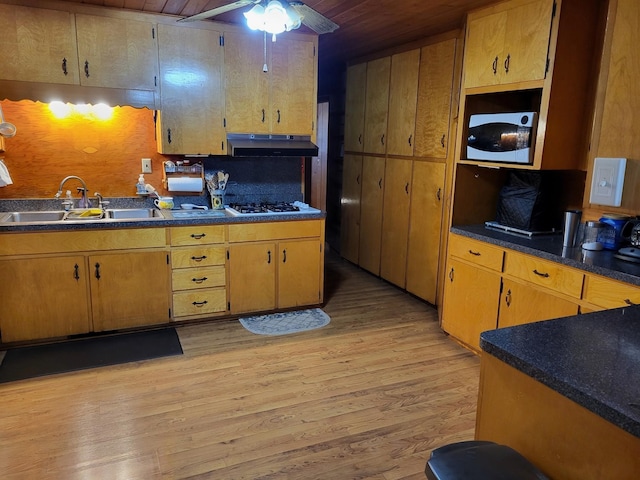 kitchen featuring ceiling fan, wood ceiling, sink, light hardwood / wood-style flooring, and backsplash