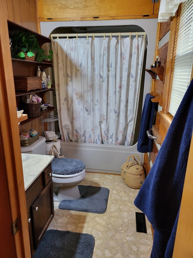 full bathroom featuring toilet, vanity, shower / bathtub combination with curtain, and wooden walls