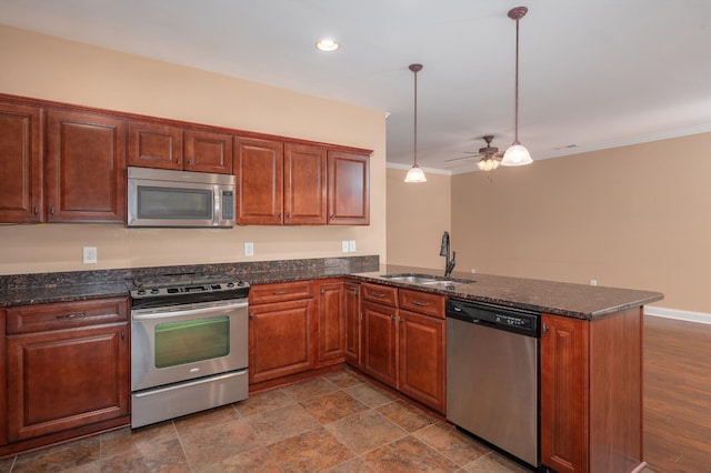 kitchen with kitchen peninsula, pendant lighting, sink, ornamental molding, and stainless steel appliances