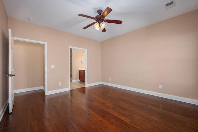 unfurnished bedroom featuring ensuite bath, ceiling fan, and dark hardwood / wood-style flooring