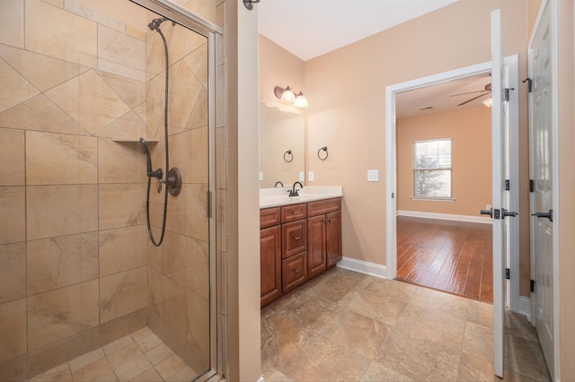 bathroom with a shower with door and vanity