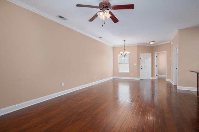 spare room featuring dark wood-type flooring, ceiling fan with notable chandelier, and ornamental molding