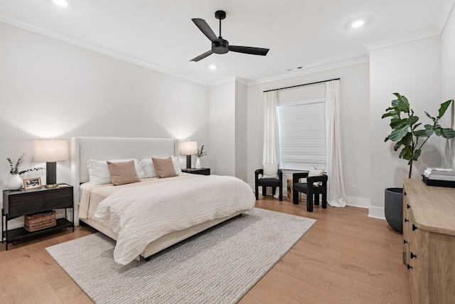 bedroom featuring crown molding, light wood-type flooring, and ceiling fan