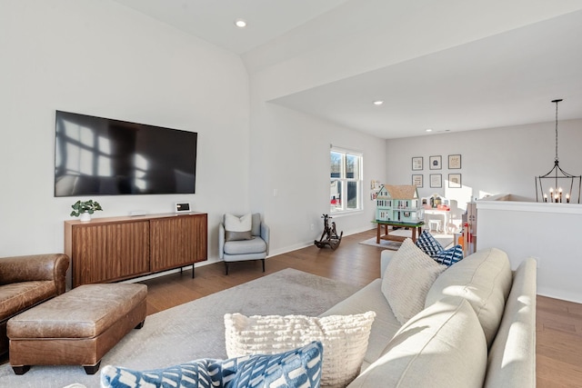 living room with wood-type flooring and an inviting chandelier