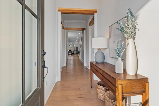 interior space with crown molding and light wood-type flooring