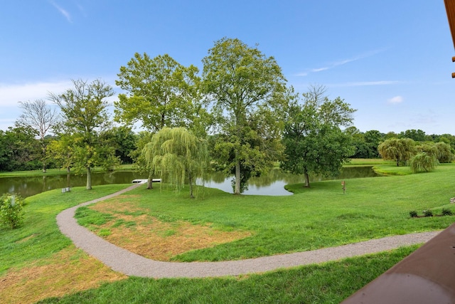 surrounding community featuring a yard and a water view