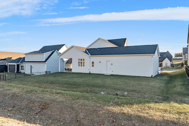 rear view of property with a lawn