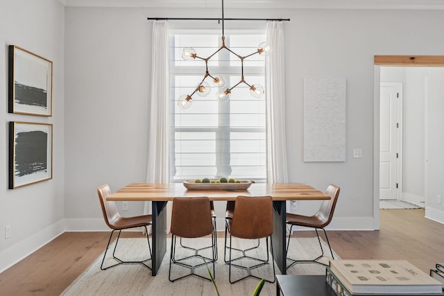 dining room featuring light hardwood / wood-style flooring and an inviting chandelier