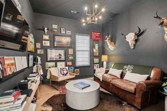 living area with an inviting chandelier and wood-type flooring