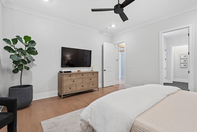 bedroom featuring light wood-type flooring, ceiling fan, and ornamental molding