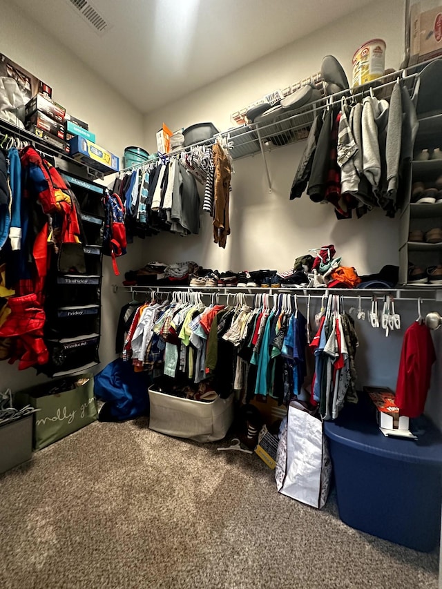 walk in closet featuring carpet