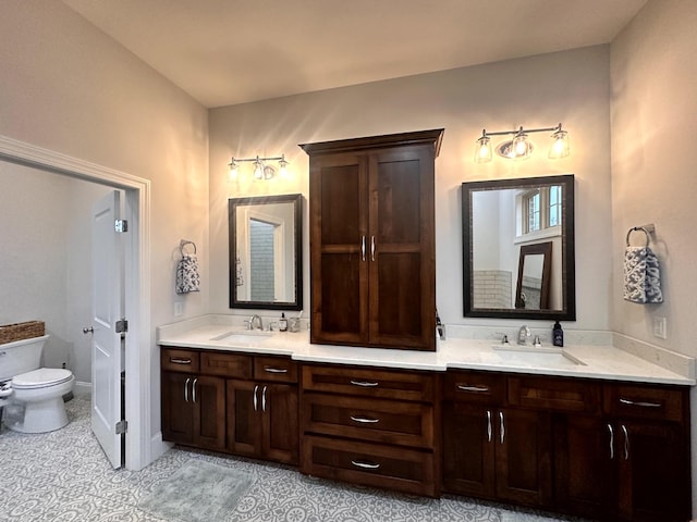 bathroom featuring toilet, vanity, and tile patterned flooring