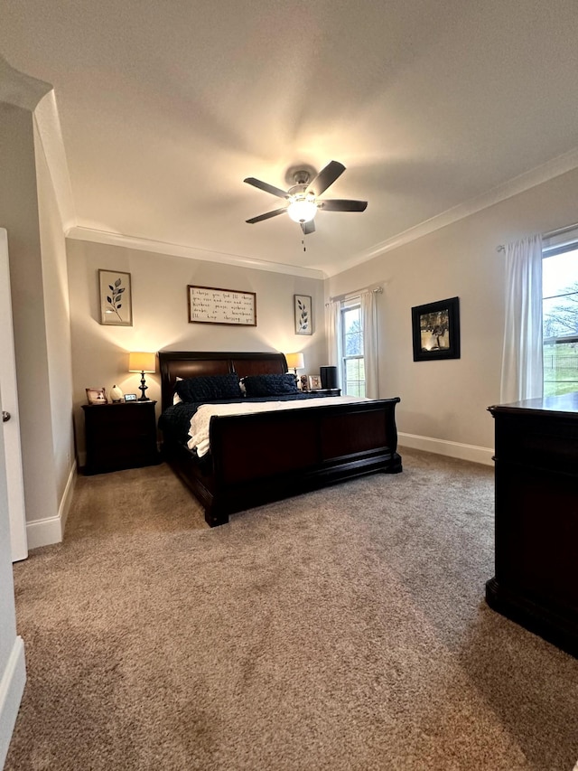 carpeted bedroom with ceiling fan and ornamental molding