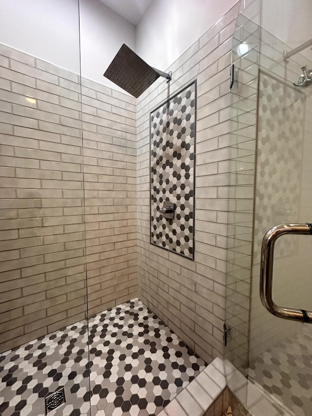 bathroom featuring a shower with door