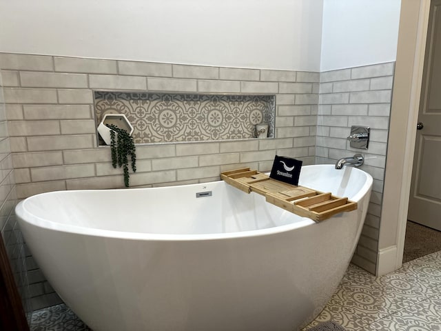 bathroom featuring tile patterned floors and a bathing tub