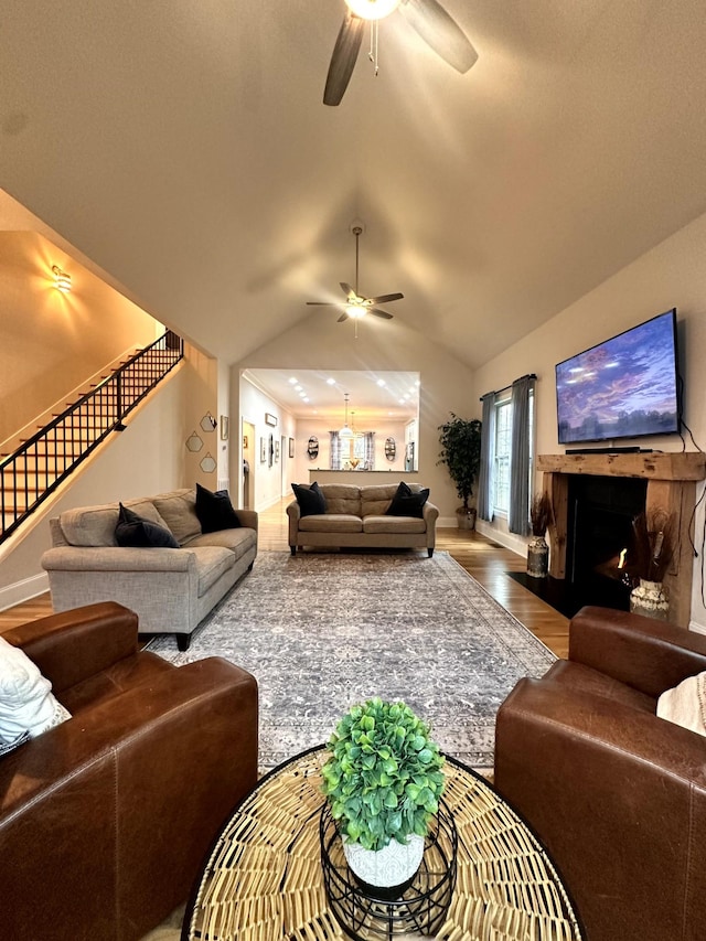 living room with ceiling fan, hardwood / wood-style flooring, and lofted ceiling