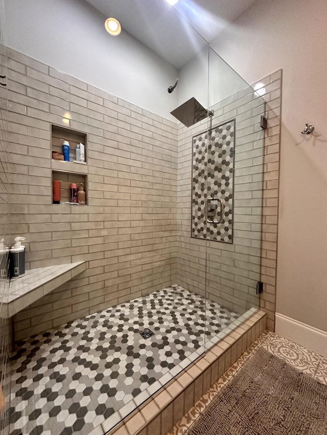 bathroom with walk in shower and tile patterned flooring