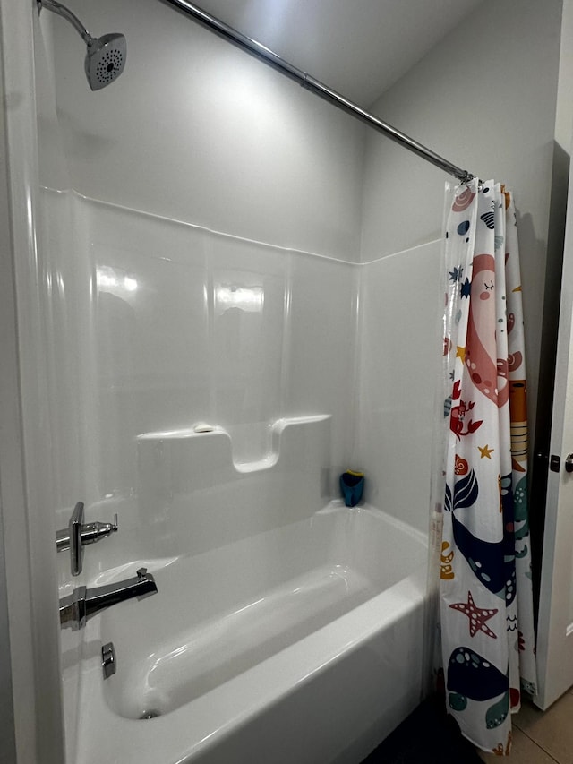 bathroom with tile patterned floors and shower / bathtub combination with curtain