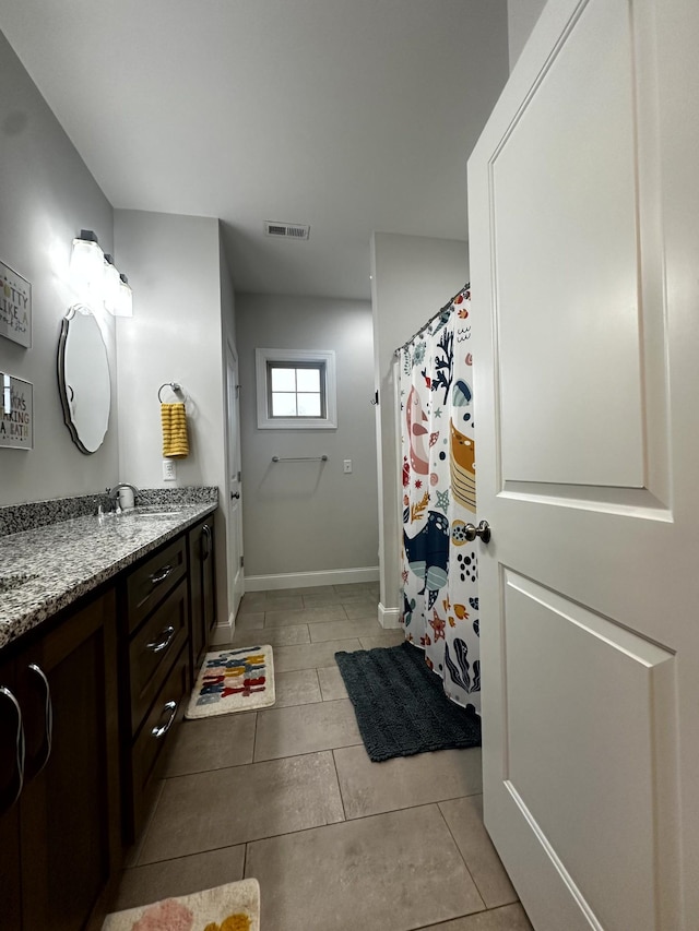 bathroom with tile patterned floors and vanity