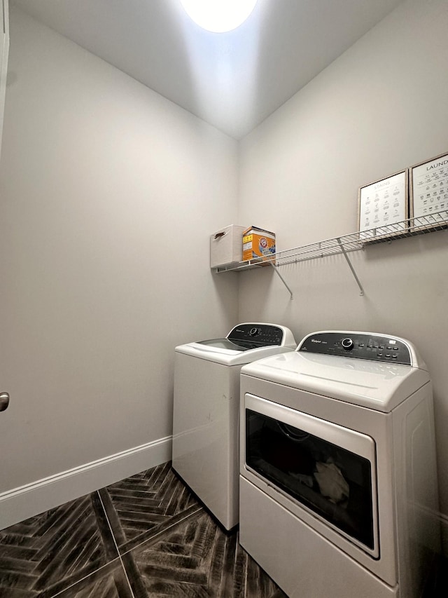 clothes washing area with washer and clothes dryer